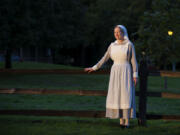 Tiffany Wilcox sports a World War I nurse’s outfit as the sun sets on the Fort Vancouver National Historic Site. Costumed volunteers like Wilcox will stroll Officers Row and answer visitor questions during the annual Summer’s End Promenade, set for 1 to 3 p.m. Saturday.