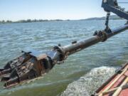 The Yaquina’s dredge arm is used on July 26.