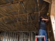 Randy Rogers of Vancouver works on the framing of entrance doors at the site of the old Namaste Indian Cuisine building in Vancouver in August. Clark County has seen a 12.2 percent increase in construction jobs in in 2018 over 2017.