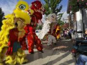 Members of the Portland Lee’s Association Lion and Dragon Dance team march around downtown Ridgefield on Saturday as part of the first Ridgefield Multicultural Festival, which started from an idea from a resident.