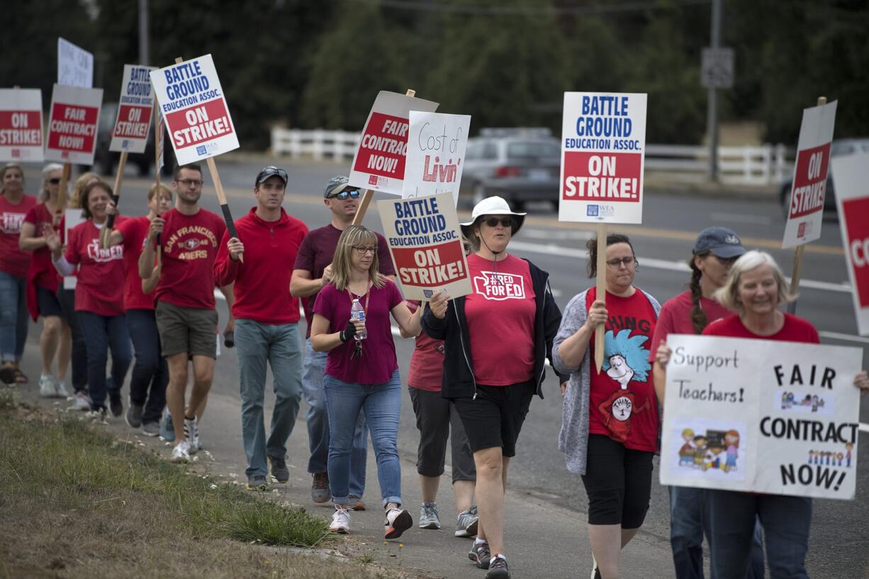 Teachers and supporters from Summit View High School and CASEE greet motorists while picketing along Lewisville Highway on Aug. 30.