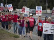 Teachers and supporters from Summit View High School and CASEE greet motorists while picketing along Lewisville Highway on Aug. 30.