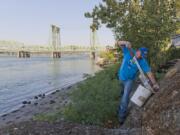 Talkin’ Trash Crew Supervisor Matt Curry cleans trash from the Columbia River waterfront. This is one of the spots his crew frequently cleans. Curry was homeless as a young adult.