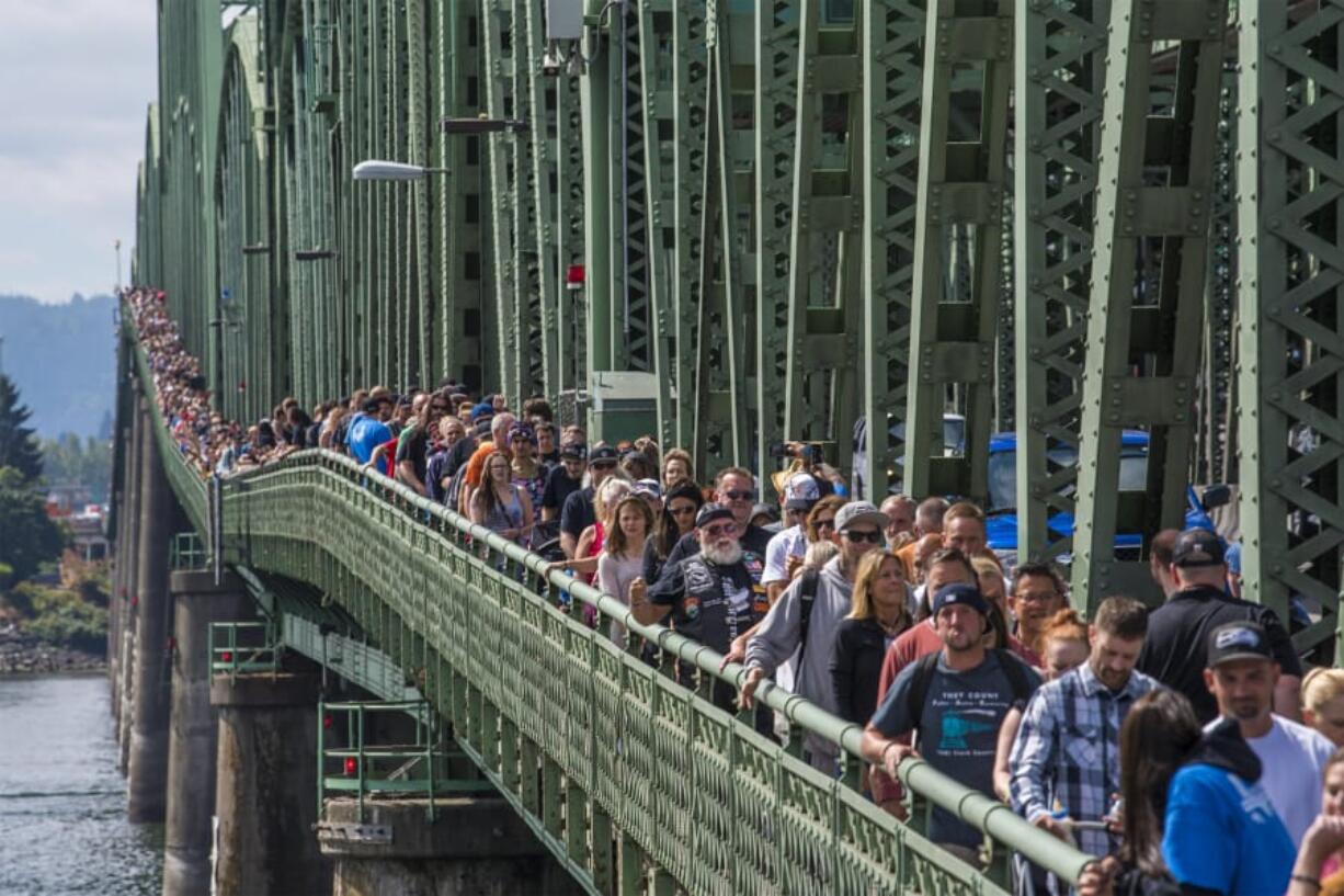 Attendees at the Hands Across the Bridge event walk the length of the Interstate 5 Bridge following the Serenity Prayer on Monday. The celebration marked the 18th anniversary of the event, in which recovering addicts come together to share their stories.