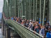 Attendees at the Hands Across the Bridge event walk the length of the Interstate 5 Bridge following the Serenity Prayer on Monday. The celebration marked the 18th anniversary of the event, in which recovering addicts come together to share their stories.