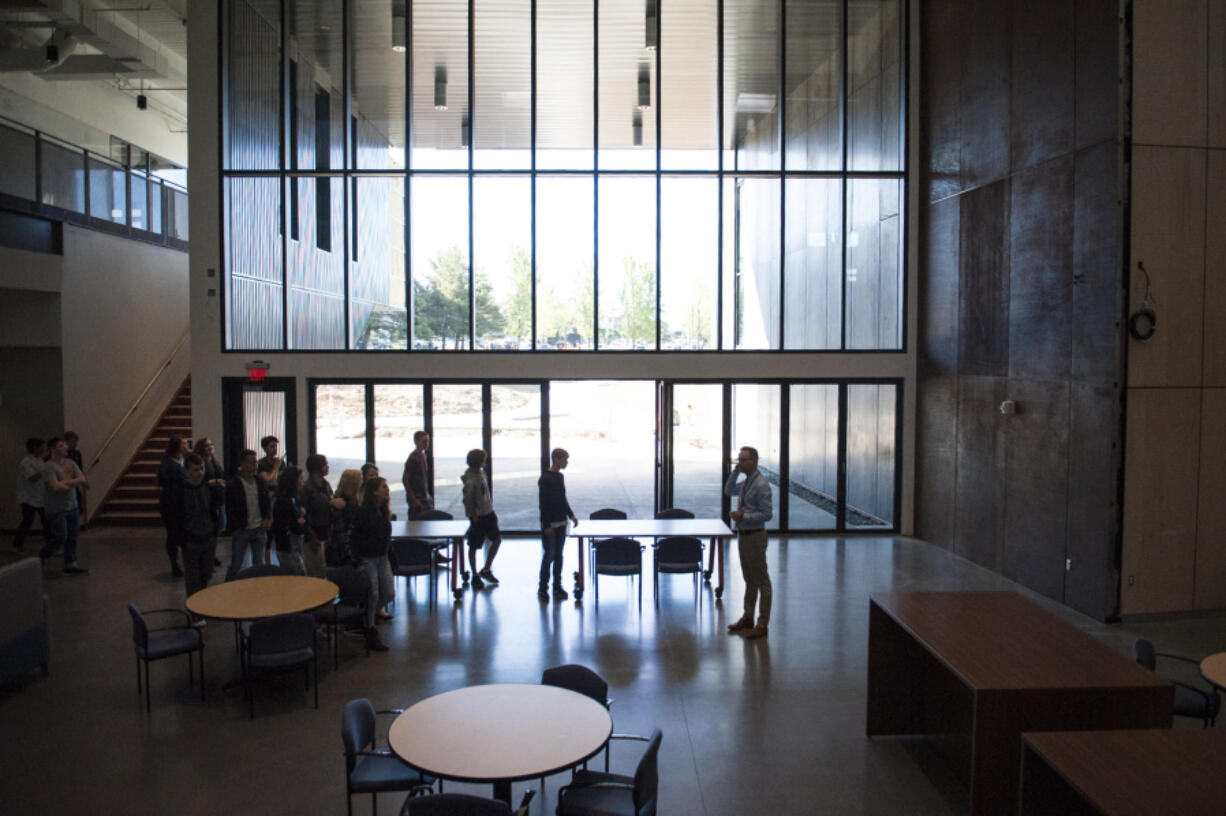 Aaron Smith, principal of Discovery High School, speaks to the freshman class during a tour on the first day of school at Discovery High School. Smith touted the amount of natural light the school allows in, which was intentional. “It’s healthy for you,” he told students.