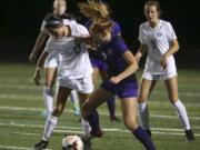 Skyview's Olivia Madden (13) and Columbia River's Reagan Griffith (7) fight for the ball. Skyview beat Columbia River, 1-0, in the the season opener on Sept. 4, 2018 at Columbia River High School in Vancouver. (Randy L.