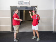 Cory Marshall, Camas High School teacher, left, and Alisa Wise, Camas High School math teacher, react following the Camas Education Association’s unanimous vote to ratify a new salary schedule for teachers. The vote allows school to start on time in Camas, and avoids a teacher strike.