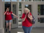 School nurse Marcia Schneider, right, shows her enthusiasm for the new contract after voting with fellow members of the Vancouver Education Association at Skyview High School on Tuesday afternoon, Sept. 4, 2018.