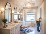 Judy Nakashima examines the bathroom of The Black Pearl at the Parade of Homes at the Camas Meadows Golf Course on Friday. The event opened Friday and will run every day until Sept. 23, except for Mondays and Tuesdays.