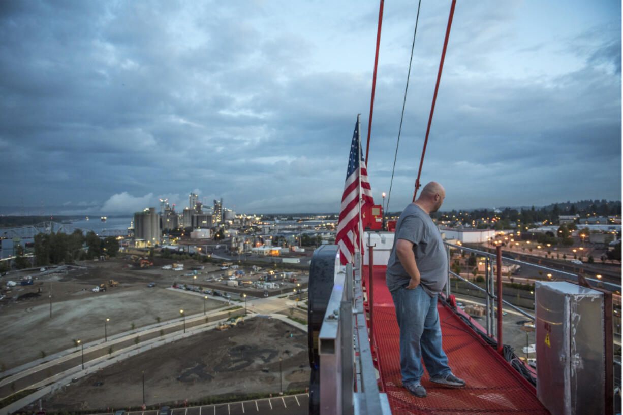 Randy Anis stands atop the tower crane he operates at The Waterfront Vancouver just after 6 a.m. Sept. 11. He has been working on the Block 8 project since October of last year. Scheduled to be completed in April 2019, the development along Columbia Way will include retail space and 188 multifamily apartment units.