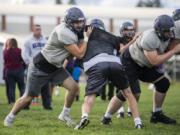 Heritage senior Andrew Thom, left, worked his way up from an undersized tight end to an all-league player who plays on offense and defense for the Timberwolves.