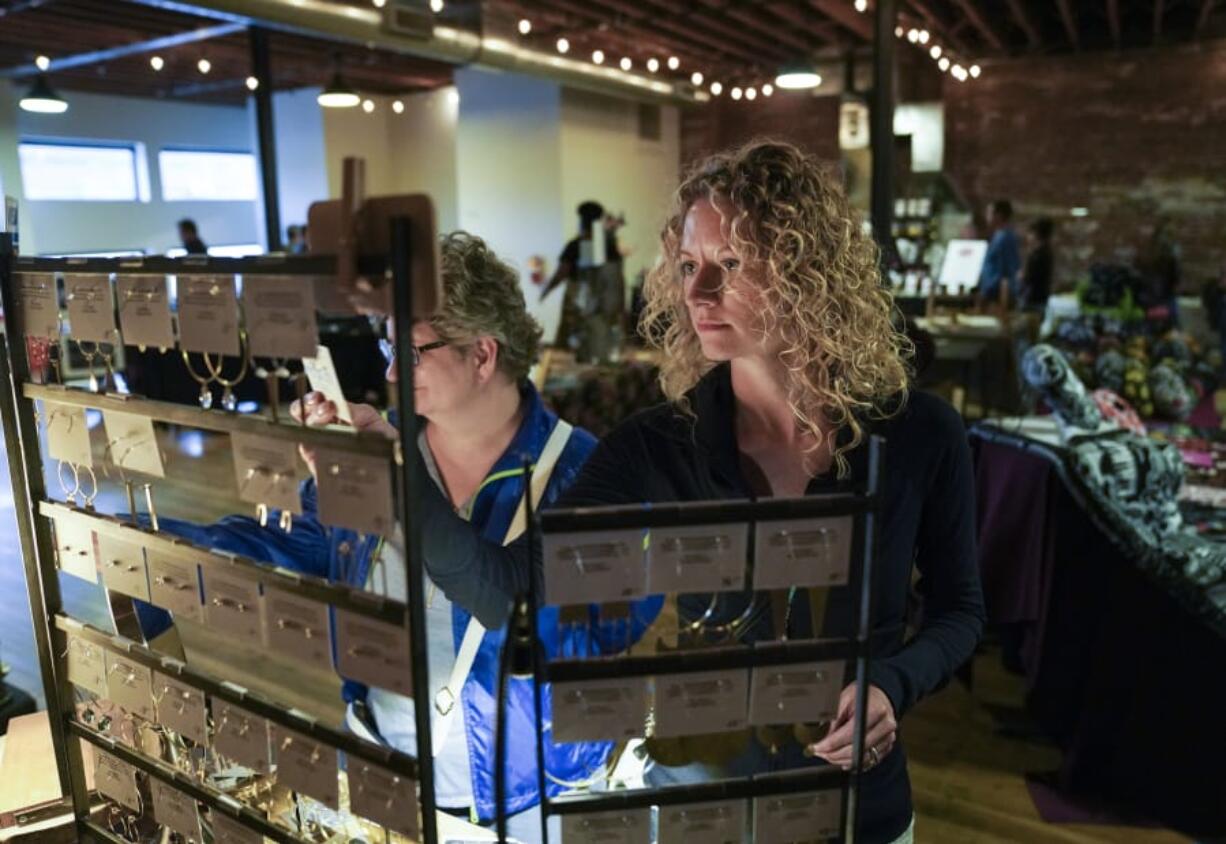 Sherina Wilson of Hood River picks out a pair of earrings from the Amaree and Resse booth during the Night Market Vancouver.