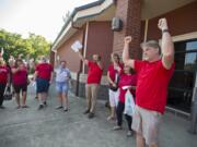 Eric Engebretson, president of the Washougal Association of Teachers, right, celebrates with fellow educators outside Washougal High School after the union unanimously ratified their new contract Thursday morning, Sept. 6, 2018.