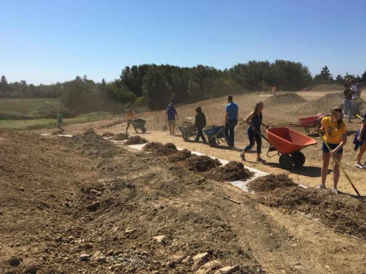 Ridgefield: New Ridgefield High School students spent part of their first day participating in Spudder Day activities, including a service project to help build a 2,000-foot trail at the Ridgefield Outdoor Sports Complex.