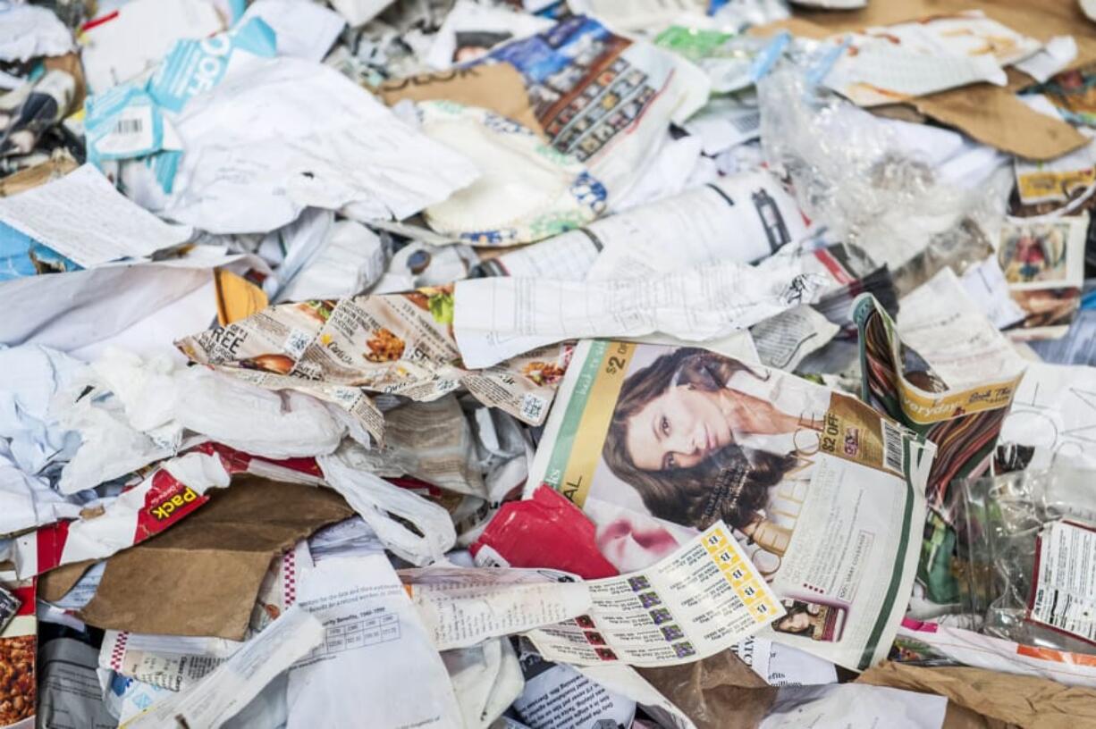 Paper and a mix of nonrecyclable material are piled at the Waste Connections material recycling facility. Officials from Clark County, the city of Vancouver and Waste Connections estimate up to 30 percent of the material that goes to the processing facility actually can’t be recycled.