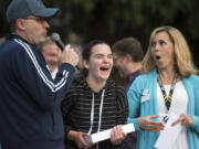 Jim Mains, with High Five Media, from left, Ava Bonner of Camas and Janie Spurgeon, vice president of development for the Community Foundation for Southwest Washington, react to Bonner’s victory in a game of Simon Says, which won her an iPad and $250 to her charity, Camas Christian Academy, during a kickoff event at Ester Short Park for Give More 24! on Thursday morning.