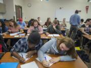 Juniors Calixta Todo, 15, left, and Kennedy Ridgway, 16, join classmates on the first day of their Advanced Placement calculus class at Henrietta Lacks Health and Bioscience High School on Monday morning.