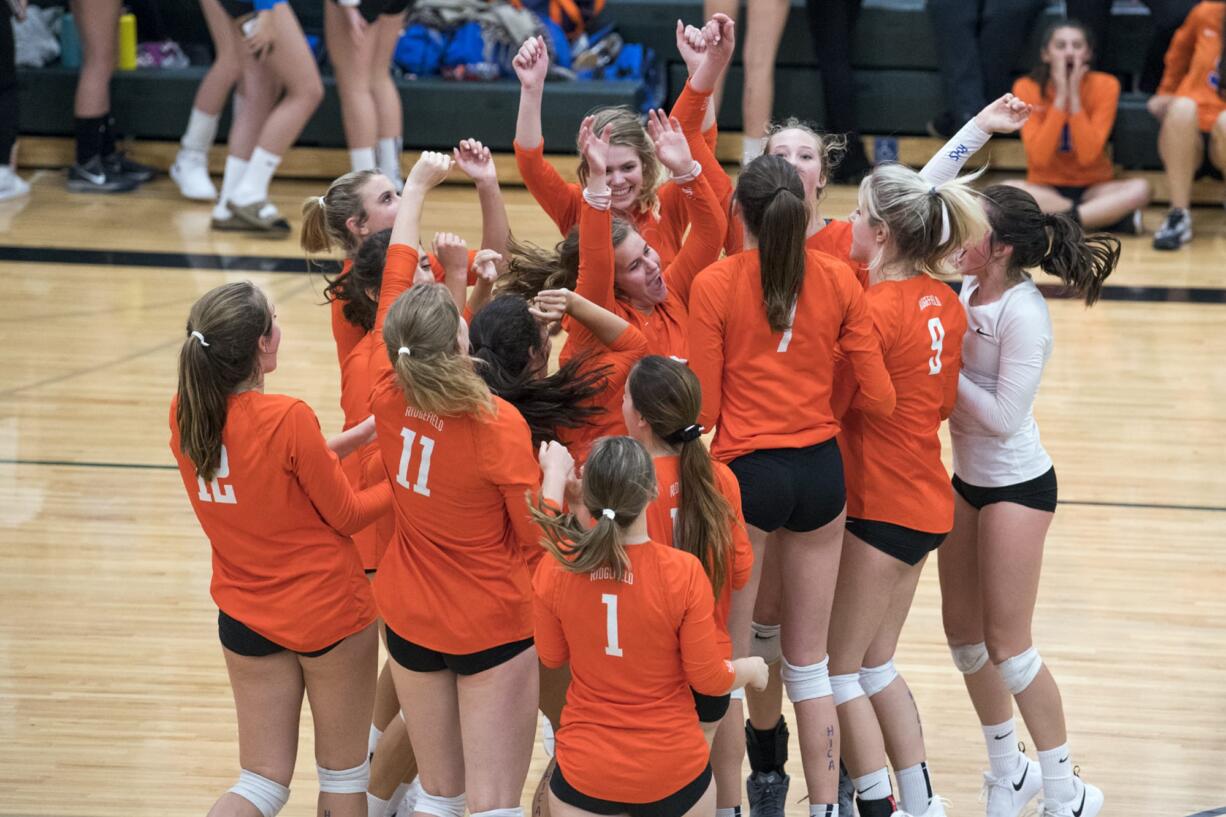 Ridgefield celebrates their win against Woodland during the game in Woodland on Tuesday, Sept. 11, 2018. Ridgefield won in three sets, 25-16, 25-22, 25-17.