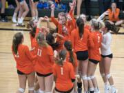 Ridgefield celebrates their win against Woodland during the game in Woodland on Tuesday, Sept. 11, 2018. Ridgefield won in three sets, 25-16, 25-22, 25-17.