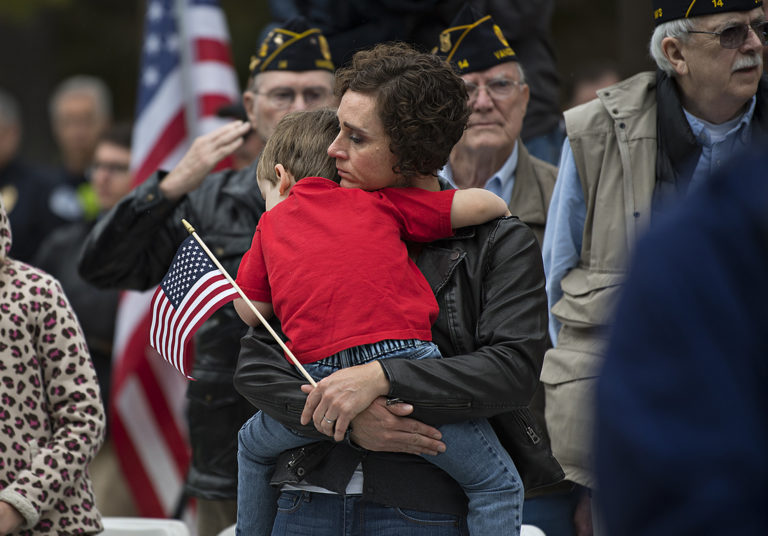 Erin Fanning of Vancouver and her son, Henry, 4, pause to honor the memory of those who died on Sept. 11, 2001 while joining the crowd outside City Hall during the annual remembrance Tuesday morning, Sept. 11, 2018. Fanning said she also came to honor those who are currently still dealing with the affects from the attack. "We're here to remember everyone," she said.