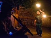 Michael Gorman dances with fire during a full moon community drum circle at Wattle Tree Place this past Saturday night. Wattle Tree’s future is uncertain; the block it sits on is being redeveloped, but the sisters who operate the business haven’t found an appropriate site for relocation.