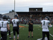 Woodland assistant coach DJ Malinowski talks with the team before its 2A Greater St. Helens League opener at Washougal on Friday.