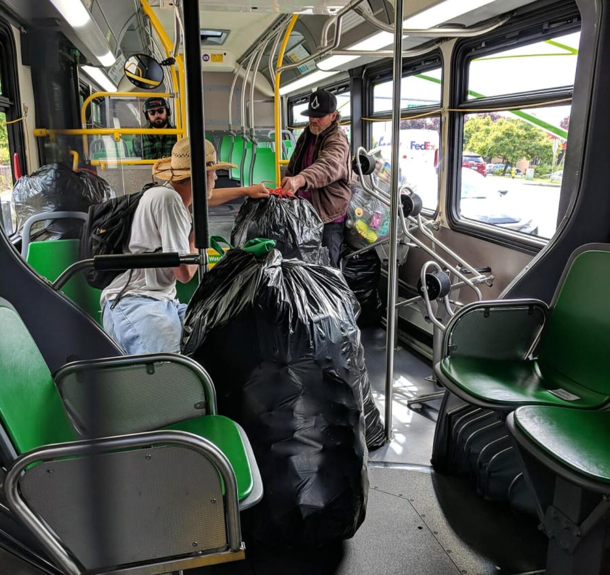 Beginning Sunday, carrying large quantities of cans aboard C-Tran will be prohibited. In this customer-provided photo, a rider carries bags of empty cans onboard The Vine.