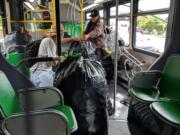 Beginning Sunday, carrying large quantities of cans aboard C-Tran will be prohibited. In this customer-provided photo, a rider carries bags of empty cans onboard The Vine.