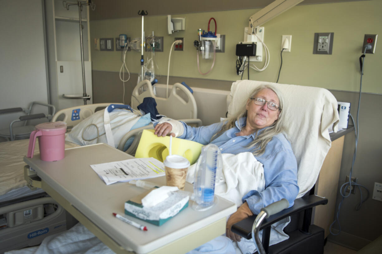 Kathrina Bateman of Skamania waits to be discharged at PeaceHealth Southwest Medical Center in Vancouver on Thursday. Bateman was attacked by five dogs on Tuesday afternoon after visiting a neighbor’s house to inquire about puppies. Her right arm was broken and her left arm and both legs were also wounded in the attack.