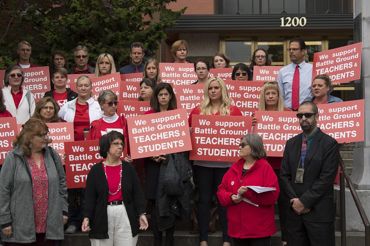 Battle Ground teachers and supporters gather on the steps at the Clark County Courthouse to speak to the media before the injunction hearing Friday morning.