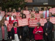 Battle Ground teachers and supporters gather on the steps at the Clark County Courthouse to speak to the media before the injunction hearing Friday morning.