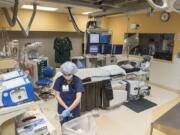 Registered Nurse Kristina Yang of Ridgefield gets a catheterization lab ready for surgery.