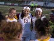 Anna Neal (13) circles up with her Prairie teammates before Tuesday night's game against Camas at Doc Harris Stadium in Camas on Sept. 18, 2018. Camas won 10-3.