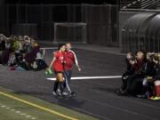 Camas' Maddie Kemp (4) is congratulated by coach Roland Minder after surpassing her 100th career goal mark during Tuesday night's game against Prairie High School at Doc Harris Stadium in Camas on Sept. 18, 2018. Camas won 10-3.