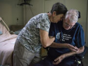 Carol Gabriel helps her husband, Lyndon Gabriel, get situated in his motorized chair after an afternoon nap at their home in Vancouver. He was diagnosed with ALS about three years ago. “I’ve had a good life,” Lyndon said.