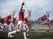 The Camas Papermakers run onto the field before Friday night's game against Bellevue at Doc Harris Stadium in Camas on Sept. 21, 2018.