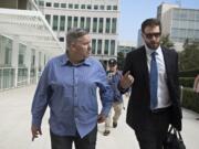 Former Vancouver pastor John Bishop, left, arrives to be sentenced for unlawful importation of a controlled substance-marijuana at the James M. Carter and Judith N Keep United States Courthouse in San Diego, Calif., on Friday morning, Sept. 21, 2018.