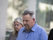 John Bishop and his estranged wife, Michelle Bishop, enter the James M. Carter and Judith N. Keep United States Courthouse in San Diego on Friday afternoon. John Bishop’s truthfulness was at issue during his hearing, which caused the judge to postpone his criminal sentencing until Monday.