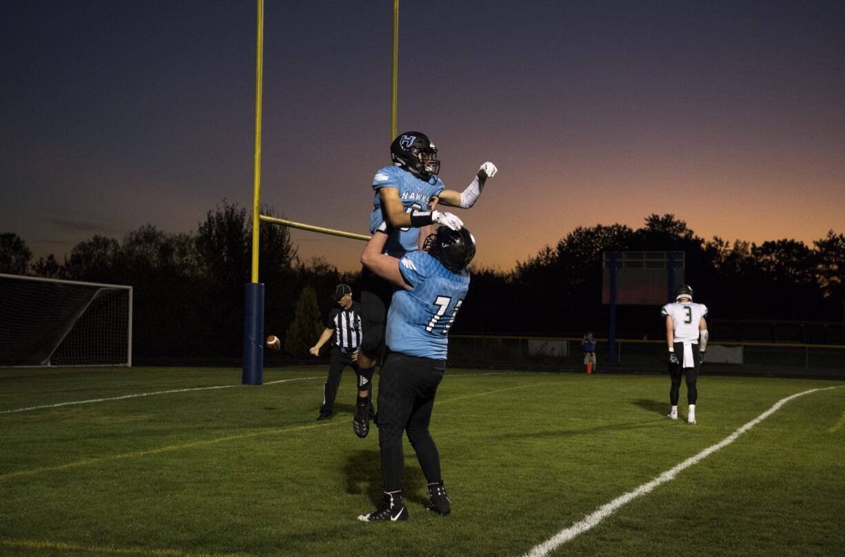 Hockinson's Peyton Brammer (9) celebrates a 26-yard touch down with teammate Nathan Balderas (71) during Friday night's game in Hockinson on Sept. 28, 2018.