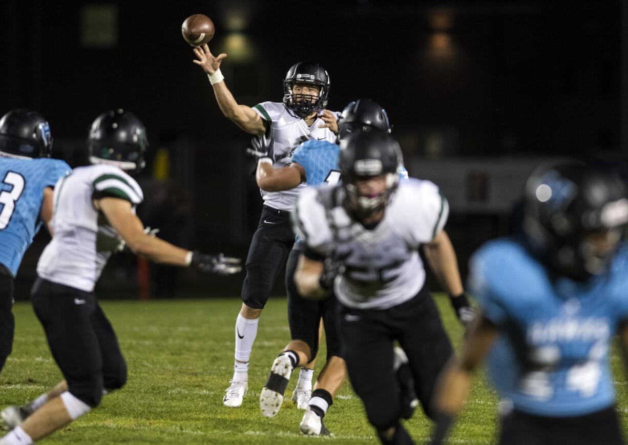 Woodland's Tyler Flanagan (21) passes the ball during Friday night's game in Hockinson on Sept. 28, 2018.