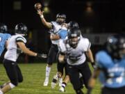 Woodland's Tyler Flanagan (21) passes the ball during Friday night's game in Hockinson on Sept. 28, 2018.