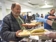 Ray Vanderslice and his Chihuahua mix, Rocky, 5, collect lunch in the newly remodeled Share House cafeteria on Wednesday. “It’s cuter,” Vanderslice said of the updated space. The men’s homeless shelter spent the summer remodeling its kitchen and ground-floor restrooms, as well as floors and lighting.