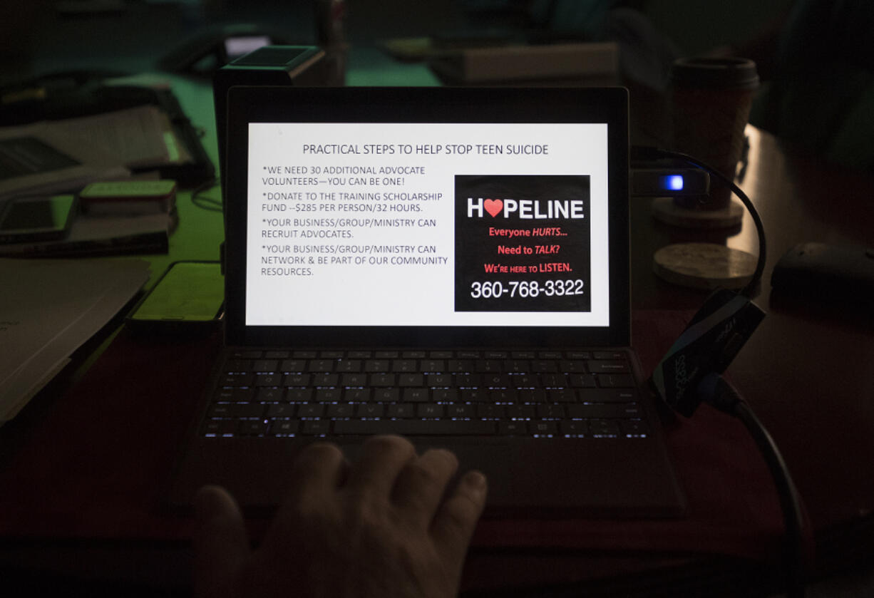 Members of the Hopeline advisory board look over a presentation about how to prevent teen suicide during a meeting at US Digital in Vancouver. The Hopeline is a faith-based 24/7 teen suicide hotline for Clark County. It begins Nov. 1.