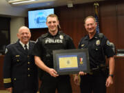 Battle Ground police Chief Bob Richardson, from left, Officer Trent Elms and Lt. Mike Fort at a ceremony honoring Elms for saving a man’s life in February.