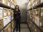 Lindsay Schultz, one of three major crimes detectives in the Clark County Sheriff’s Office, stands in the archive room of the sheriff’s office.