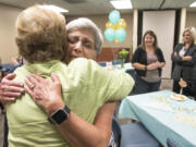 Kathi Anderson, left, hugs Lorreta Holcomb on Friday during an event celebrating Holcomb’s 50 years working for some variation of PeaceHealth Southwest Medical Center in Vancouver. The two women met in high school and worked together for more than 20 years.