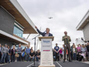 Barry Cain, owner of Gramor Development, speaks while a plane flies over head the Vancouver Waterfront Park grand opening on Saturday afternoon, Sept. 29, 2018.