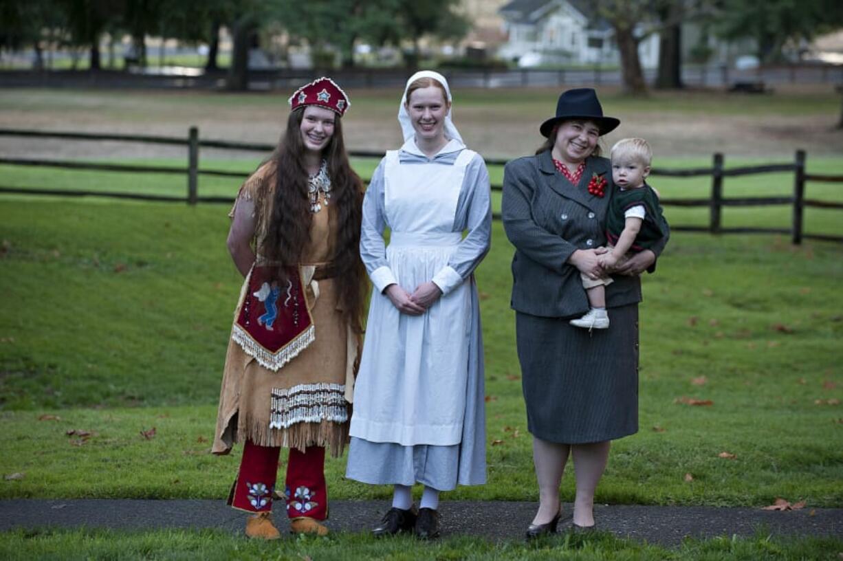 Megan Wilcox, left, her sister, Tiffany Wilcox, and Shelly Toews and son Nathaniel show off some of the fashions you would have seen around the Fort Vancouver National Historic Site during its long, storied history. Megan Wilcox is dressed as Sarah Winnemucca from the 1880s; Tiffany Wilcox wears a nurse’s outfit from Word War I; and Shelly Toews and her son, Nathaniel, wear styles from the 1940s. Fashionable characters from history will be promenading along Officers Row on Saturday.