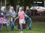 Sartu Mohammed, 9, at center, tries hula hooping with her family Saturday during the Fourth Plain Multicultural Festival.